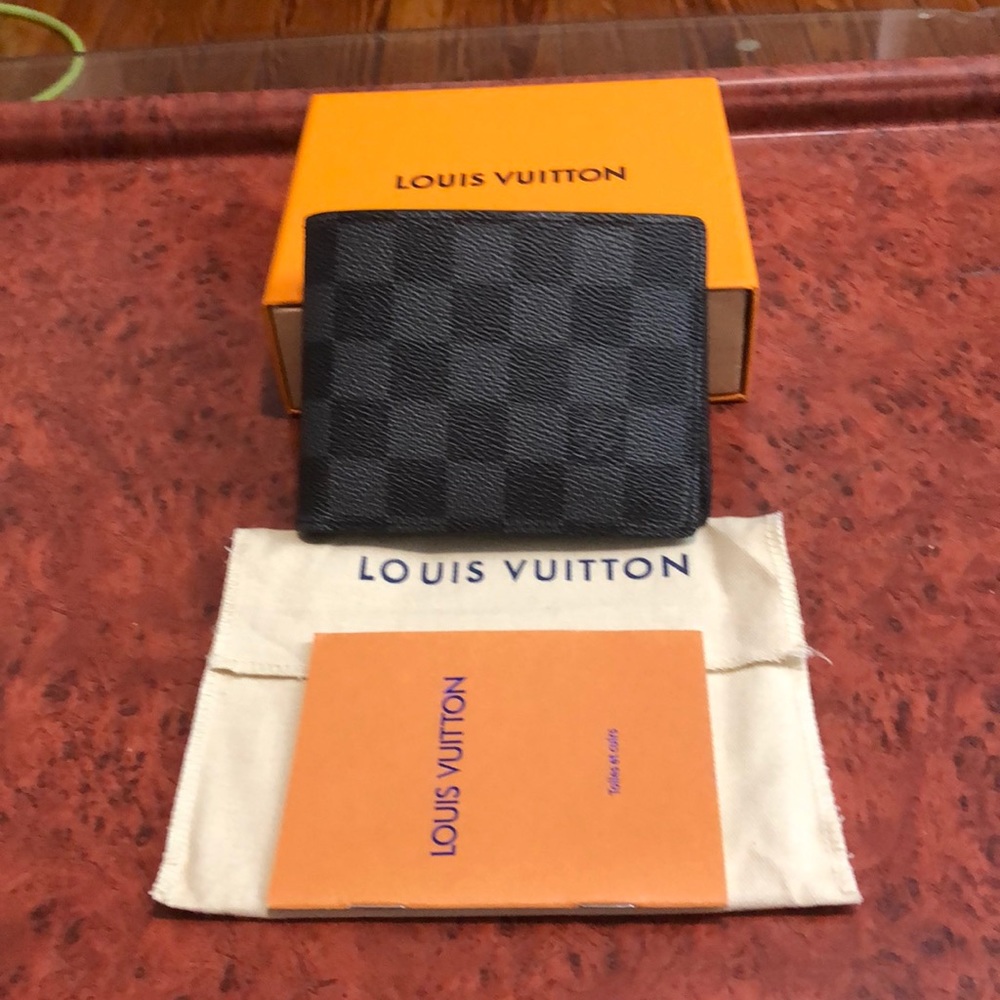 Louis Vuitton men’s gray multiple Damier wallet.